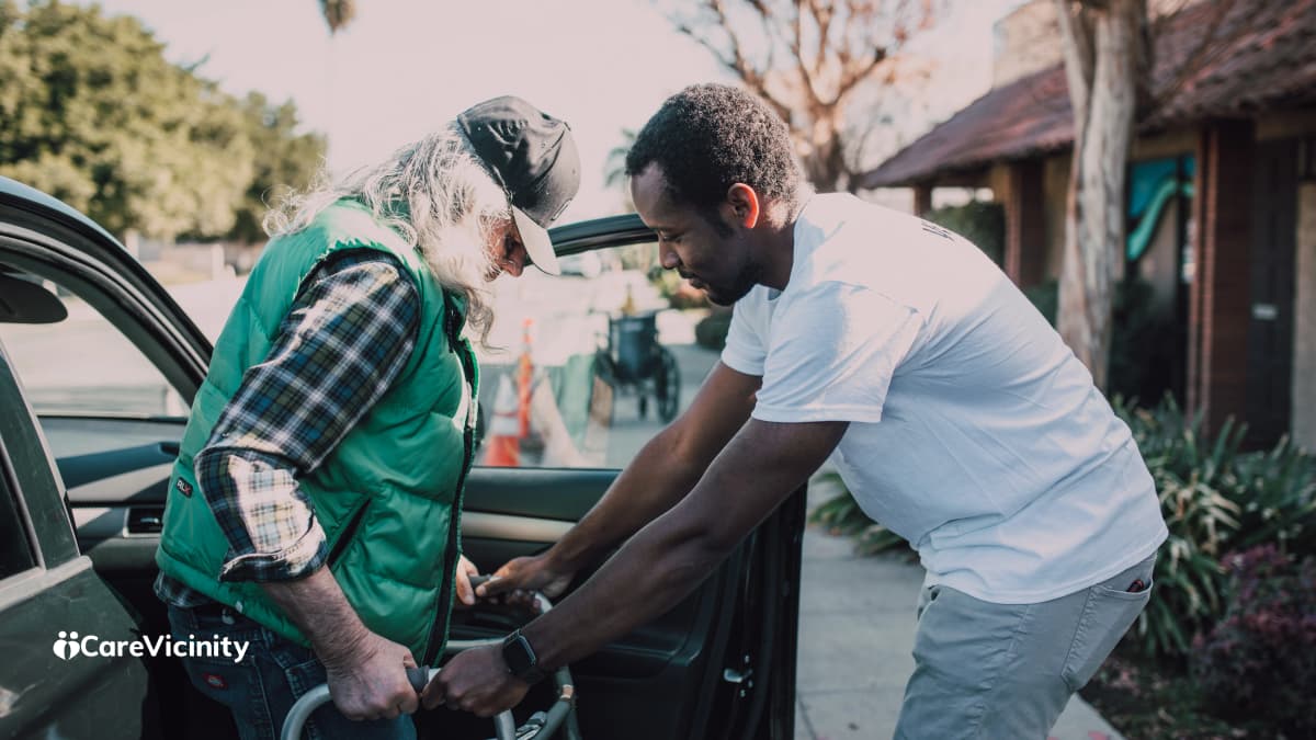 Two care coordinators reviewing client schedules together on a shared screen