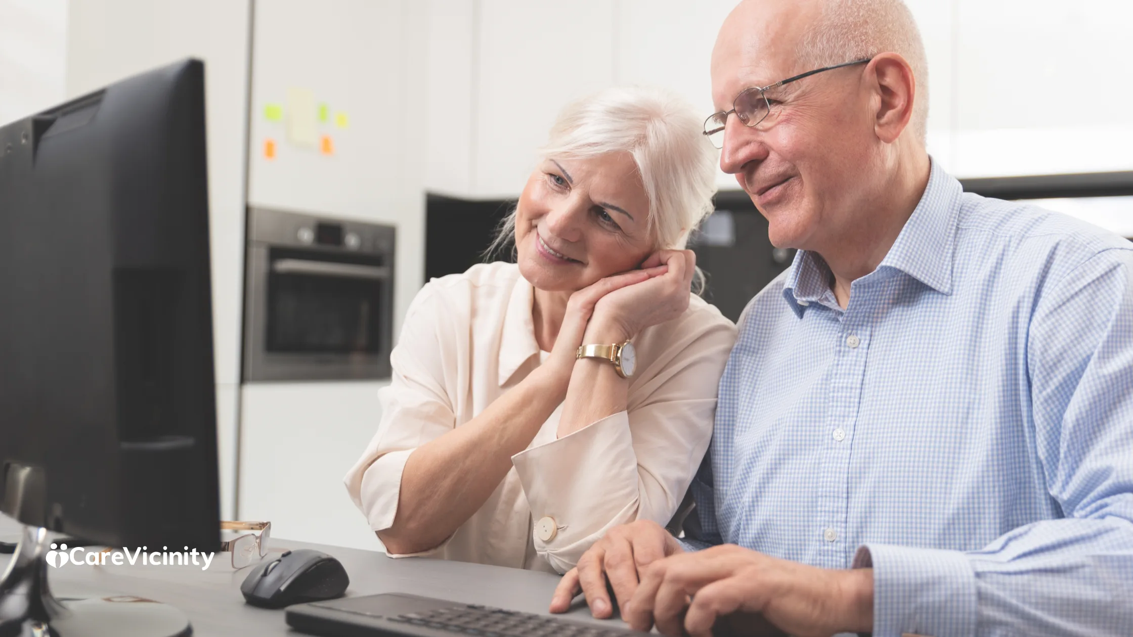 Older couple looking at a desktop computer together at home