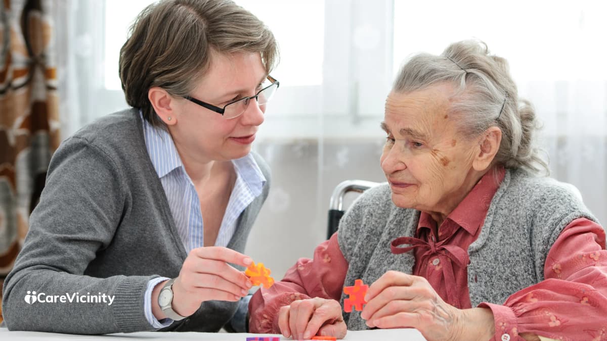 Two women sitting together at a table, talking