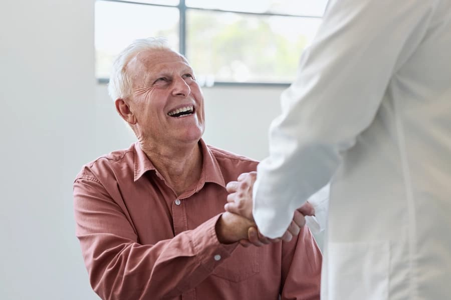 Older man smiling during a friendly handshake
