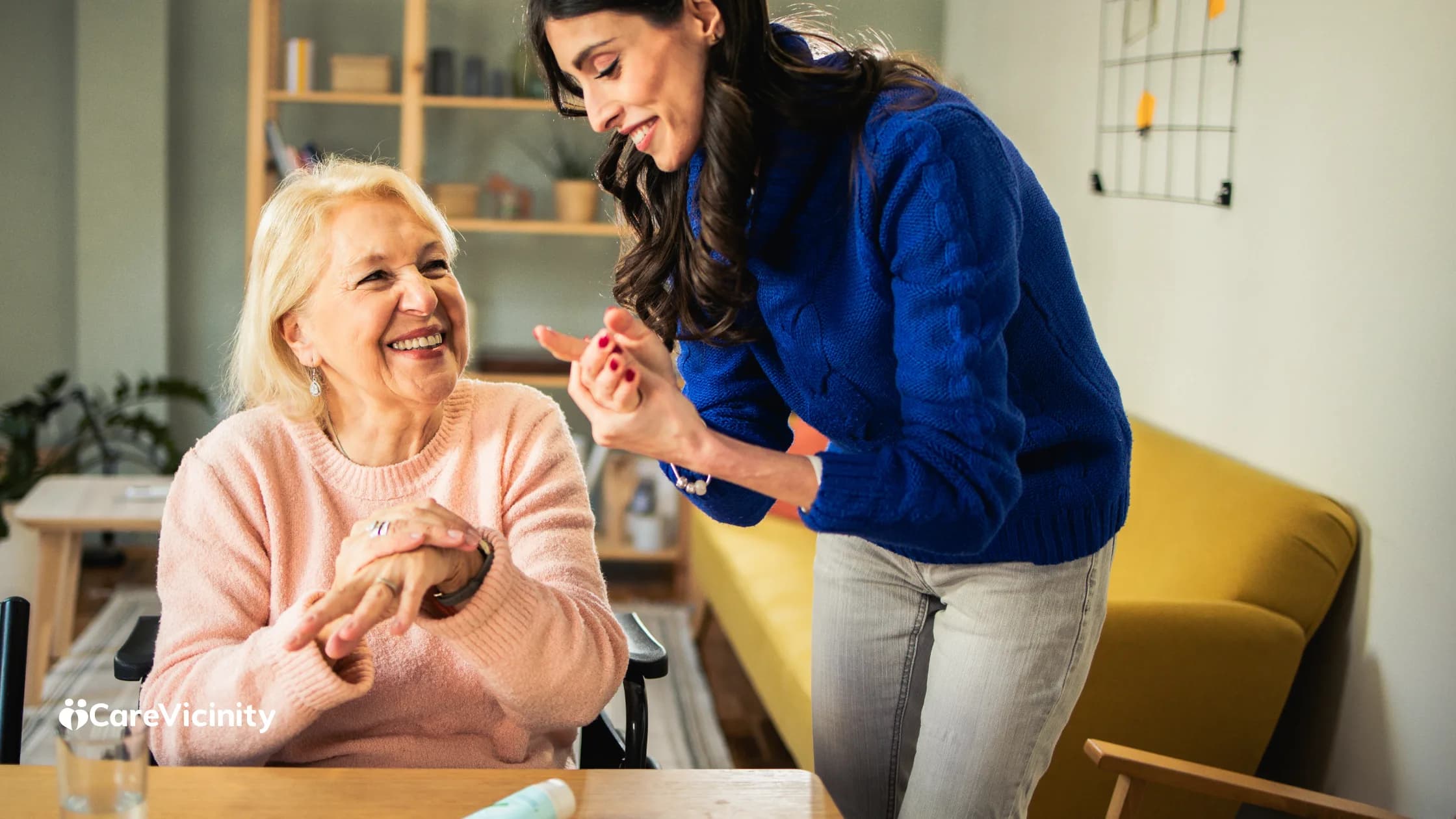 Support worker and older client sharing a warm moment at home