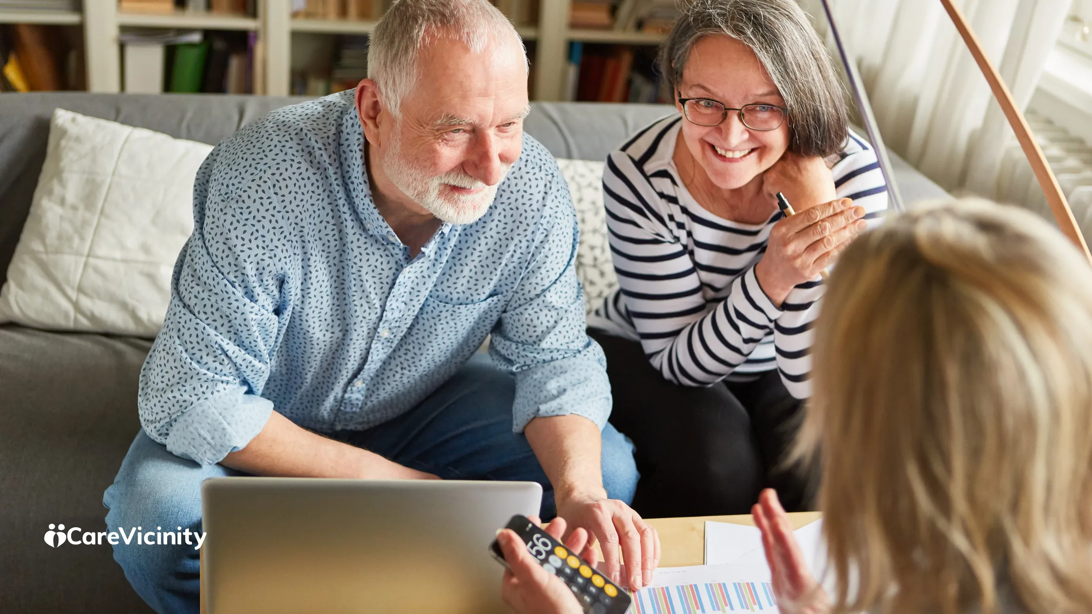Coordinator reviewing a support worker agreement with a client and family member on a laptop